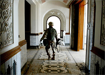 R _A US marine walks through a hallway of Iraqi President Saddam Hussein's palace in the ancient town of Babylon, April 20, 2003. Since the U.S.-led ouster of Saddam, Iraqis have attacked the ubiquitous images of their former leader, scratching his moustachioed face from posters, chiselling his eyes out of mosaic frescoes or beheading his statues. But in Babylon, famed for its ancient hanging gardens, palace curator Mohammed Thaer said removing Saddam’s legacy would take time -- especially as he first had to repair the site’s museum that looters have ransacked in the postwar power vacuum. REUTERS/Jerry Lampen REUTERS