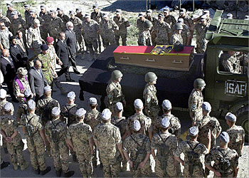 f_German soldiers from the International Security Assistance Force ( ISAF) form a guard of honour for one of four of their comrades killed in a suicide car bomb attack in the Afghan capital that also wounded 31 other German troops, 10 June 2003. Some 1,000 troops turned out to pay their last respects before their bodies were transported to Kabul airport to be repatriated to Cologne, Germany. AFP PHOTO / SHAH Marai