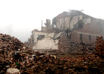 The destroyed office building at the blast site of a fireworks factory is seen in Xinji City, north China's Hebei Province, July 29, 2003. A powerful explosion destroyed a firecracker factory on July 28, killing 29 people and injuring more than 100, state television said on Tuesday. NO ARCHIVES, NO SALES REUTERS/Xinhua/Yang Shirao
