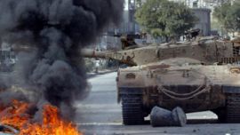 r: An israeli army tank rolls near burning tires during clashes in Balata refugees camp, near the West Bank town of Nablus