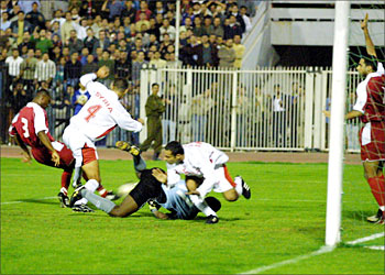 f_ Syria's Iyad Abdel Karim (2nd L), Jomah Khater (L) and goalkeeper Walid Salem of the United Arab Emirates tussle in front of the Emirati goal during their 2004 Asia Cup qualifier in Damascus 07 November 2003. The UAE won 3-1. Others are unidentified. AFP PHOTO/Louai BESHARA