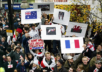Rugby fans show their support as they cheer on the England Rugby team during the Victory Parade in London, 08 December, 2003. Later the England Rugby World Cup winners were travelling to receptions at Buckingham Palace and Downing Street.