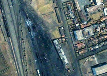 r: A satellite photo of the North Korean city of Ryongchon, also known as Yongchon, taken May 13, 2003 shows the train line running from the top left of the image to the bottom centre.