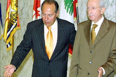 r_Lebanon's President Emile Lahoud (L) walks out of his office after a meeting