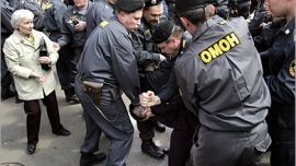 AFP - Members of the special police forces OMON arrest a supporter of the jailed founder of Russian oil giant Yukos Mikhail Khodorkovsky outside the court house in Moscow,