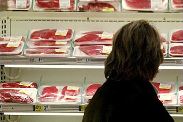 REUTERS/ An unidentified shopper looks over the selection of steaks at local grocery store in Chicago, in this December 24, 2003 file photo. A second case of mad cow disease in the United