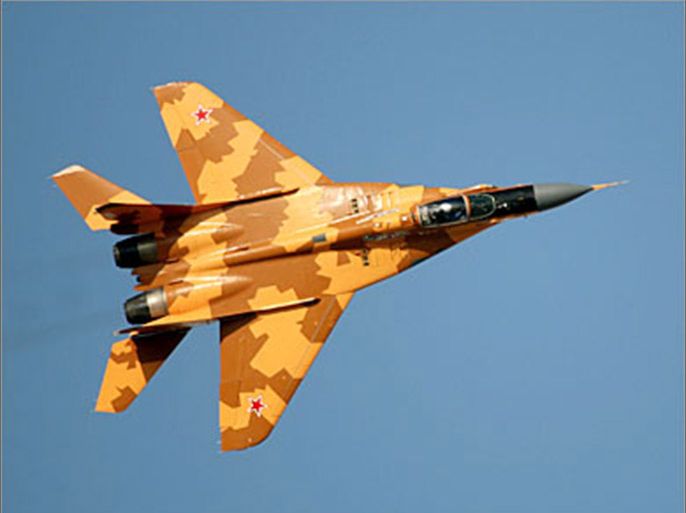 REUTERS/ A Russian MIG 29 flies at the Dubai Air show, November 20, 2005. Airline Emirates placed a $9.7 billion order for the wide-bodied Boeing Co. 777 planes on Sunday in a deal that