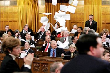 r_Members of Parliament react after hearing the results of a vote in the House of Commons