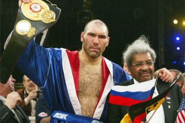 Russian boxer Nikolai Valuev (L) and U.S. boxing promoter Don King celebrate after defeating World Boxing Association (WBA) heavyweight champion John Ruiz in Berlin December 18, 2005
