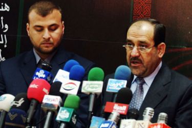 Iraq's Minister of Transportation Salam al-Maliki (L) and Shi'ite politician Jawad al-Maliki, both members of the United Iraqi Alliance, speak at a news conference in Baghdad