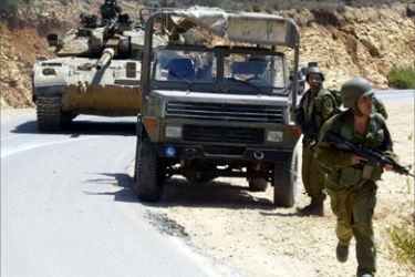 Israeli troops roll along a road near the northern Israeli town of Zar'it close to the Israeli Lebanese border 12 July 2006, following the capture early today of two Israeli soldiers by the Lebanese-based Hezbollah.