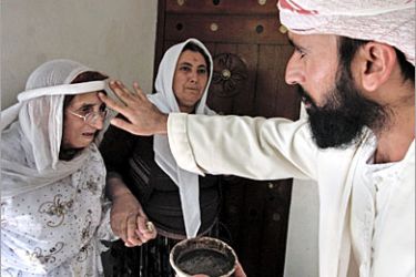 AFP - An Iraqi Yazidi Sheikh gives his blessing to a woman at the Lalish temple situated in a valley near Dohuk, 430 Kilometers (260 miles) northwest of Baghdad as they prepare for the