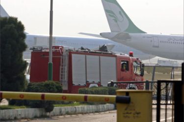 A fire engine is parked at Tehran's Mehrabad airport 27 November 2006, following the crash of a military plane after take-off, killing all 39 people on board