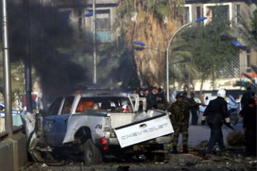 Smoke rises from a destroyed police vehicle shortly after a bomb attack in Baghdad, January 18, 2007