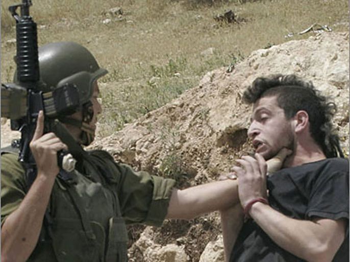 REUTERS/An Israeli soldier scuffles with an Israeli activist during a protest against a road block south of the West Bank city of Hebron May 9, 2007