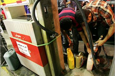 AFP / Iranians pump gasoline into flasks at a petrol station in downtown Tehran, late 26 June 2007. Angry Iranian youths attacked a petrol station in Tehran 26 June 2007, burning a