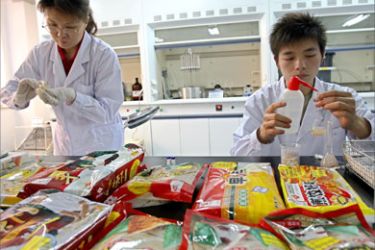 In this 12 June 2007 file photo shows Chinese lab technicians collecting food samples at the Beijing administration for industry and commerce center for food safety test in Beijing.