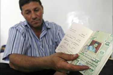 r_Assad Abdul Kadhum, a 41-year-old Iraqi refugee, displays his Iraqi passport at his home in Amman, July 26, 2007. He has lived in Jordan since 1999 with his sister Halah and her