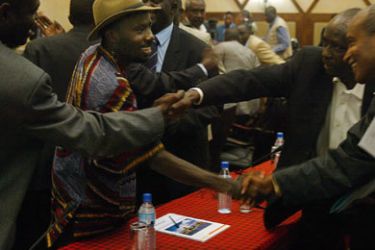 Darfur rebel faction representatives including Ahmed Abdelshafir (2ndL) and Sharif Harir (2ndR) shake hands following the official opening of an Africa Union-United
