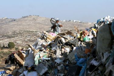 AFP/ A Palestinian man collects scrap metal at a garbage dump at the edge of the Israeli occupied West Bank village of Shuqba, 22 August 2007.