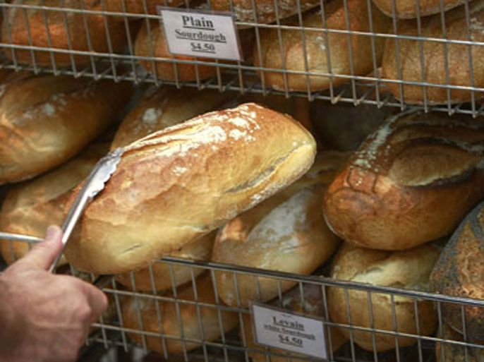 A baker removes a loaf bread from a rack in his North Sydney Bakery September 18, 2007. Australia chopped its official forecast of its 2007/08 wheat crop by 31 percent