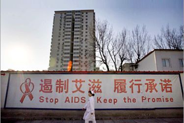 REUTERS/ A nurse walks past a sign near the special HIV/AIDS ward during her morning rounds at the Beijing You An Hospital November 30, 2007. An estimated 700,000 people are living with HIV/AIDS in China, with the rates of infections slowing this year. But China's efforts to prevent HIV/AIDS-related