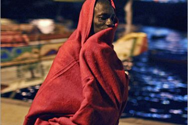 REUTERS/ A would-be immigrant rests at the port of Los Abrigos on Spain's Canary island of Tenerife November 24, 2007. Some 172 would-be immigrants were intercepted aboard a fishing