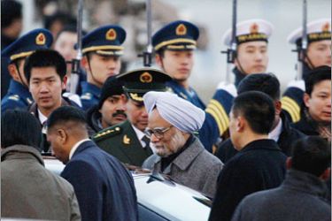 REUTERS/Indian Prime Minister Manmohan Singh (C) walks towards a car after arriving at Beijing International Airport January 13, 2008