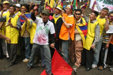 Tibetan demonstrators shout anti-Chinese slogans and tread on a Chinese flag during a protest in Siliguri on March 18, 2008.