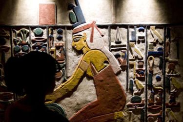 A woman looks at an Egyptian painted wall on display as part of the exhibition "Isis and the Feathered Serpent", in the National Museum of Anthropology and History in Mexico City,