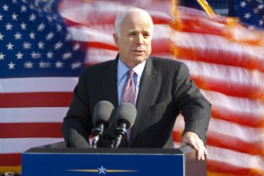 Presumptive Republican Presidential nominee, US Senator John McCain delivers remarks at the US Navy and Marine Corps Memorial Stadium as US flags behind him blow