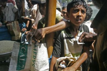 A Bangladeshi boy is scolded for attempting to jump the food queue for cooking oil and rice in Dhaka on April 8, 2008. Spiralling food prices in impoverished Bangladesh have left more and more people going hungry and authorities have to further increase aid, a minister warned