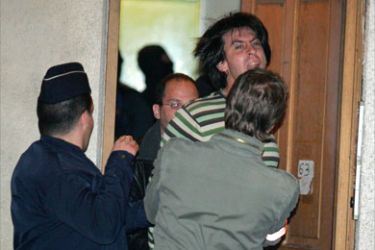One of the four suspected members of Basque rebels ETA (unidentified) shouts while being escorted by police during the night early on May 22, 2008
