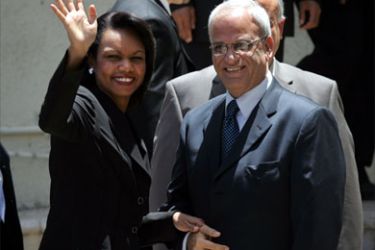 US Secretary of State Condoleezza Rice waves while being greeted by Palestinian negotiator Saeb Erakat (R) upon her arrival for a meeting with Palestinian president Mahmud Abbas at his headquarters in the West Bank city of Ramallah, on June 15, 2008