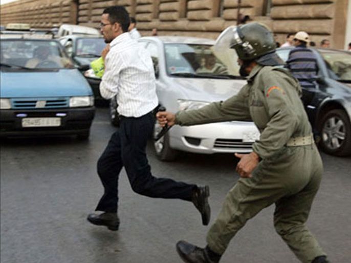 r : A police officer chases after a demonstrator during a protest in Rabat July 2, 2008. More than 1000 people blocked an avenue as they demanded for more public sector jobs.