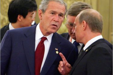 AFP / US President George W. Bush (L) chats with Russian Prime Minister Vladimir Putin prior to a welcome banquet at the Great Hall of People on August 8, 2008 in Beijing. World