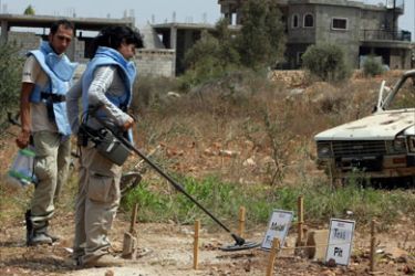 Demining personnel test their equipment in a field in the village of Siddiqin in southern Lebanon on August 26, 2008.