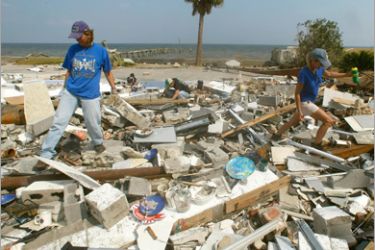 AFP - Mary Anne Schmitz (R) and Kay Hoffman (L) look for items in the rubble where Schmitz's beach home once stood before Hurricane Ike demolished it September 19, 2008 in
