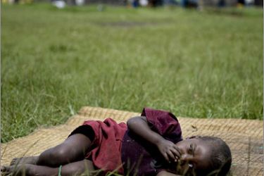 AFPA child rest on a mat in the patio of a school near the Kibumba internally displaced people's (IDP) camp on October 12, 2008. An improvised