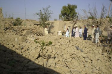 Tribesmen gather at a site of a missile attack on the outskirts of Miranshah, near the Afghan border, October 12, 2008. Suspected U.S. drones fired two missiles on Saturday