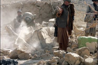 f/Afghan villagers search destroyed a house in the village of Wocha Bakhta in Kandahar Province on November 5, 2008.