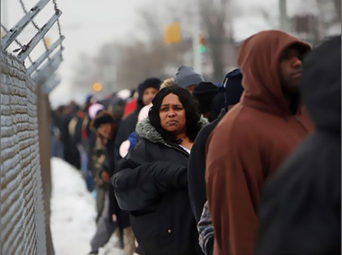 AFPDETROIT - DECEMBER 18: People wait in a several block line to receive gifts of food, personal care and household items and toys at the A Miracle in Motown event