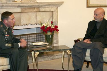 r : Afghan President Hamid Karzai (R) meets with U.S. Central Command chief General David Petraeus in Kabul in this handout picture taken January 20, 2009. Picture taken