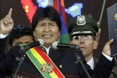 r : Bolivian President Evo Morales holds the new Constitution as he makes his first speech after promulgating it in a public gathering of his supporters, in El Alto on the outskirts of La