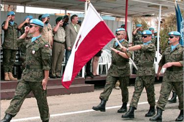 AFP - An undated handout picutre obtained from the United Nations Interim Force In Lebanon's (UNIFIL) press office shows Polish soldiers working with the UNIFIL holding a national flag