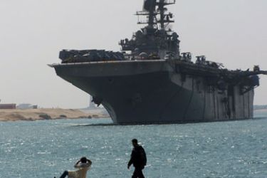 afp/ Egyptian men look at the multipurpose amphibious assault ship USS Iwo Jima (LHD 7) as it transits through the Suez Canal on its way to the Mediterannean on March 1, 2009.