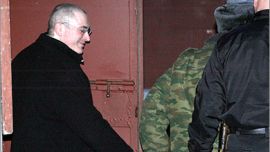 AFP - Jailed Russian oil tycoon Mikhail Khodorkovsky is led out of a Moscow court in handcuffs on March 3, 2009 after the first day of hearings in his new trial. Khodorkovsky's lawyer said