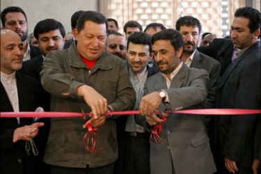 afp : Iranian President Mahmoud Ahmadinejad (C-R) and his Venezuelan counterpart Hugo Chavez (C-L) cut the ribbon during the inauguration of the Iran-Venezuela Bank in Tehran