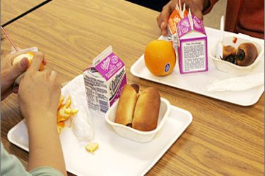REUTERS/ Students have a nutrition break mid-morning consisting of milk, juice, an orange and either mini sausage roll or Vegetarian Italian bagel at Belmont High School in Los Angeles, California May 18, 2009. Los Angeles Unified School District is an anti-junk-food pioneer, but the obstacles it faces show how difficult it is to change habits shaped by
