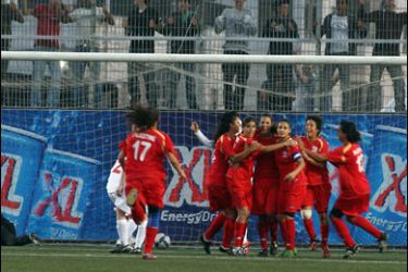 Palestinian national women's football team players celebrate at the end of their first match against Jordan at the Faisal Husseini Stadium in the West Bank town of Al-Ram, near Jerusalem, on October 26, 2009. The Jordanian-Palestinian women's football match ended in 2-2 draw